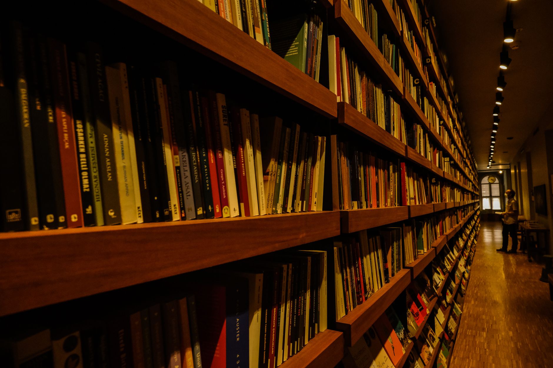 Rows of books on wooden shelves inside an independent bookstore