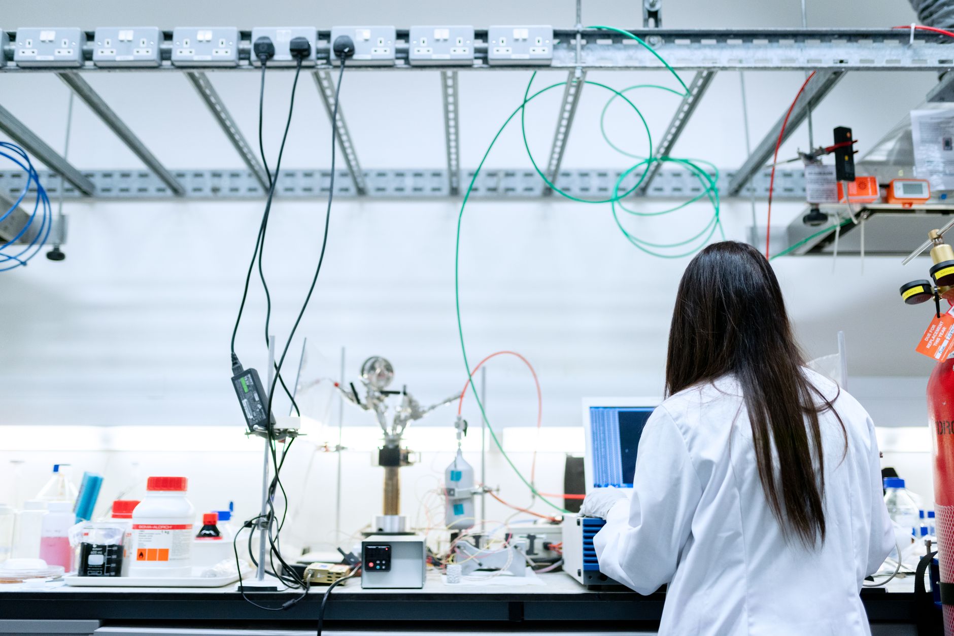 Researcher working at a computer terminal in a technology laboratory