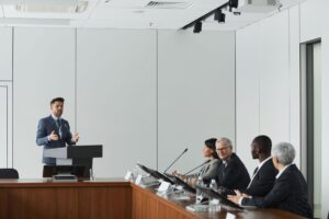 A speaker at a podium addressing an audience at a political event