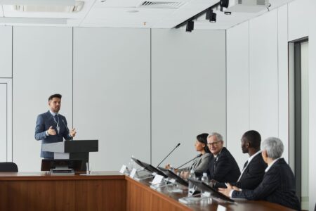 A speaker at a podium addressing an audience at a political event