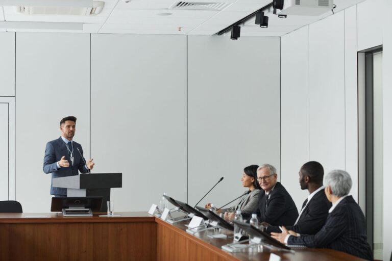 A speaker at a podium addressing an audience at a political event