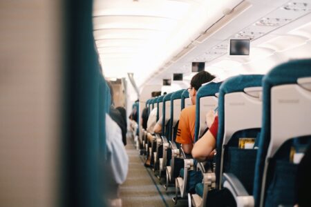 Passengers seated inside a commercial airplane cabin