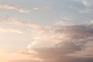 Soft morning clouds gathered against a pale sky, evoking the lyric imagery in Bachmann's prose