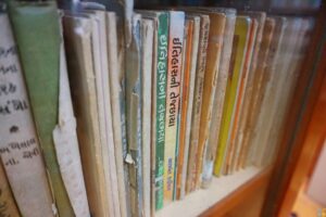 Rows of aged books on wooden library shelves