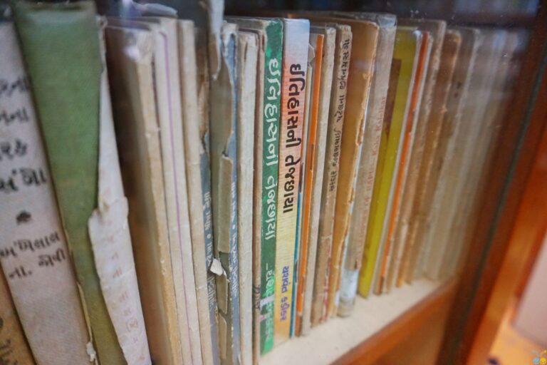 Rows of aged books on wooden library shelves
