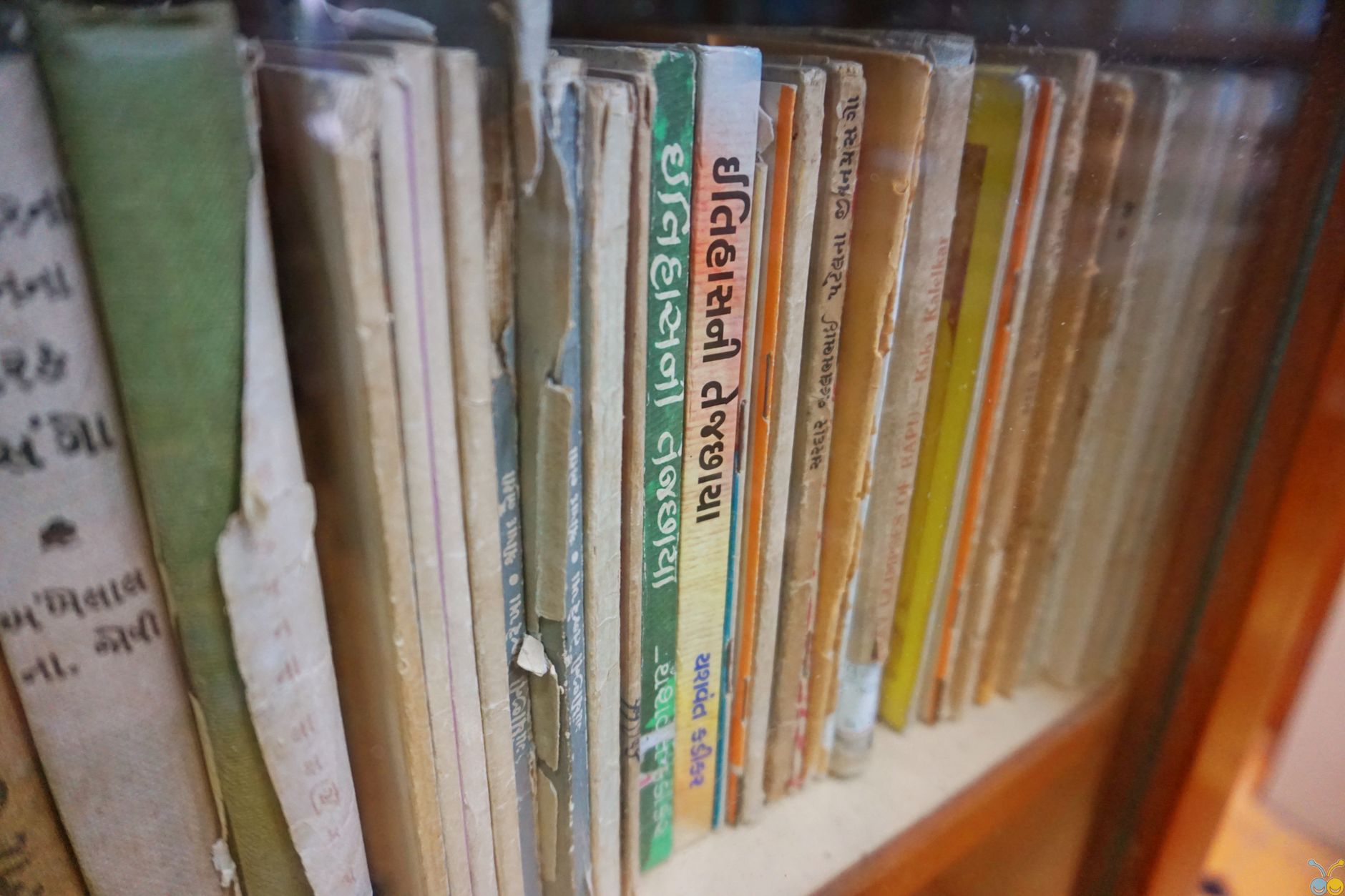 Rows of aged books on wooden library shelves