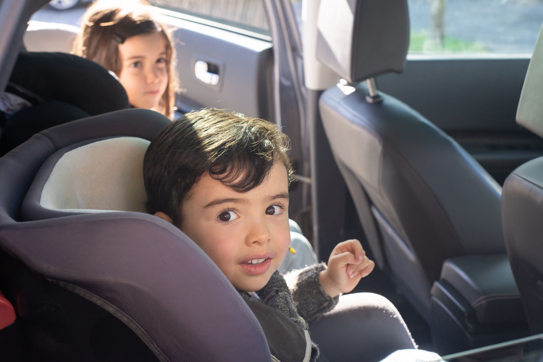 A family loading bags into a car before a road trip