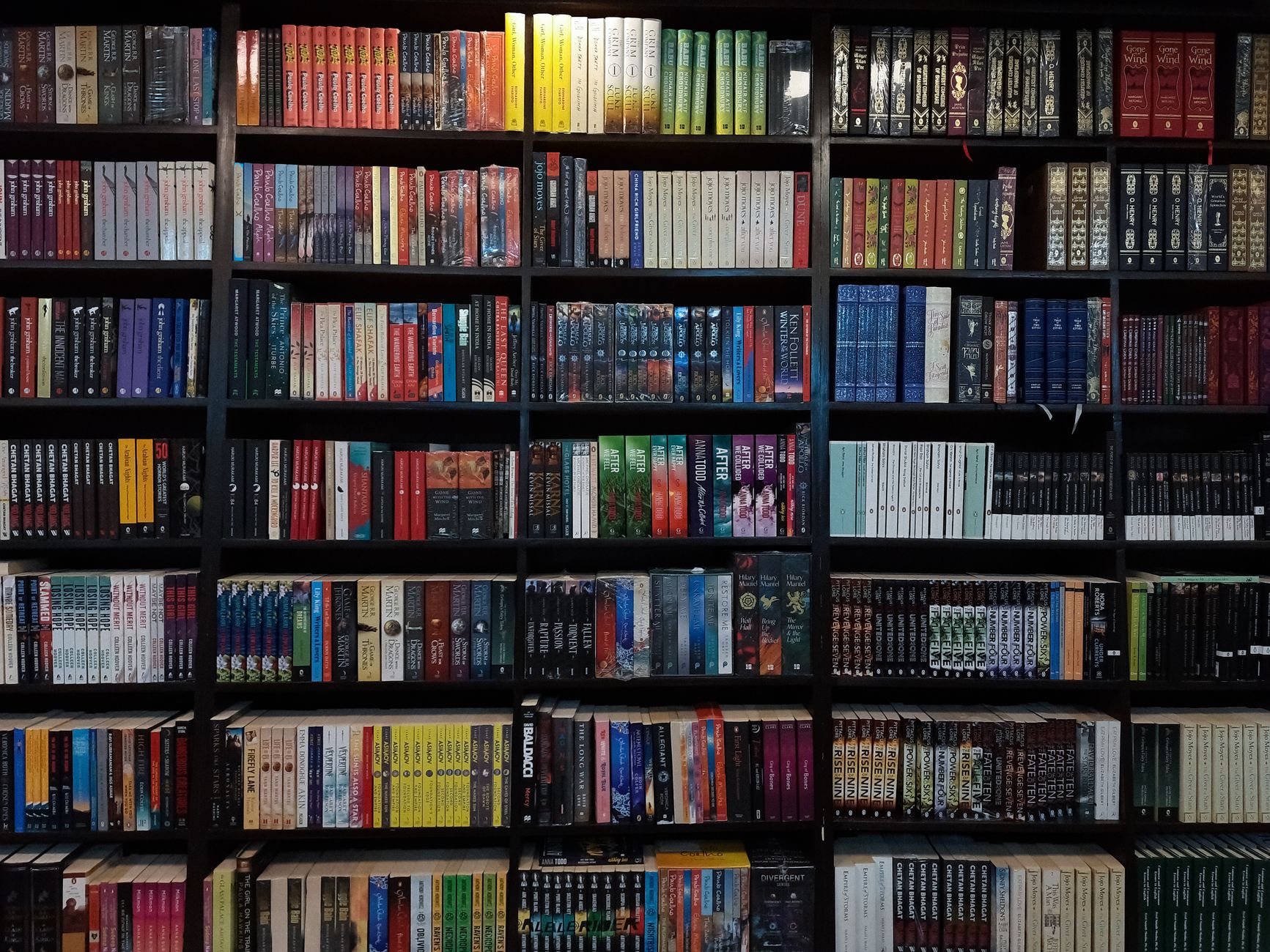 Stack of science fiction and fantasy novels on a wooden table