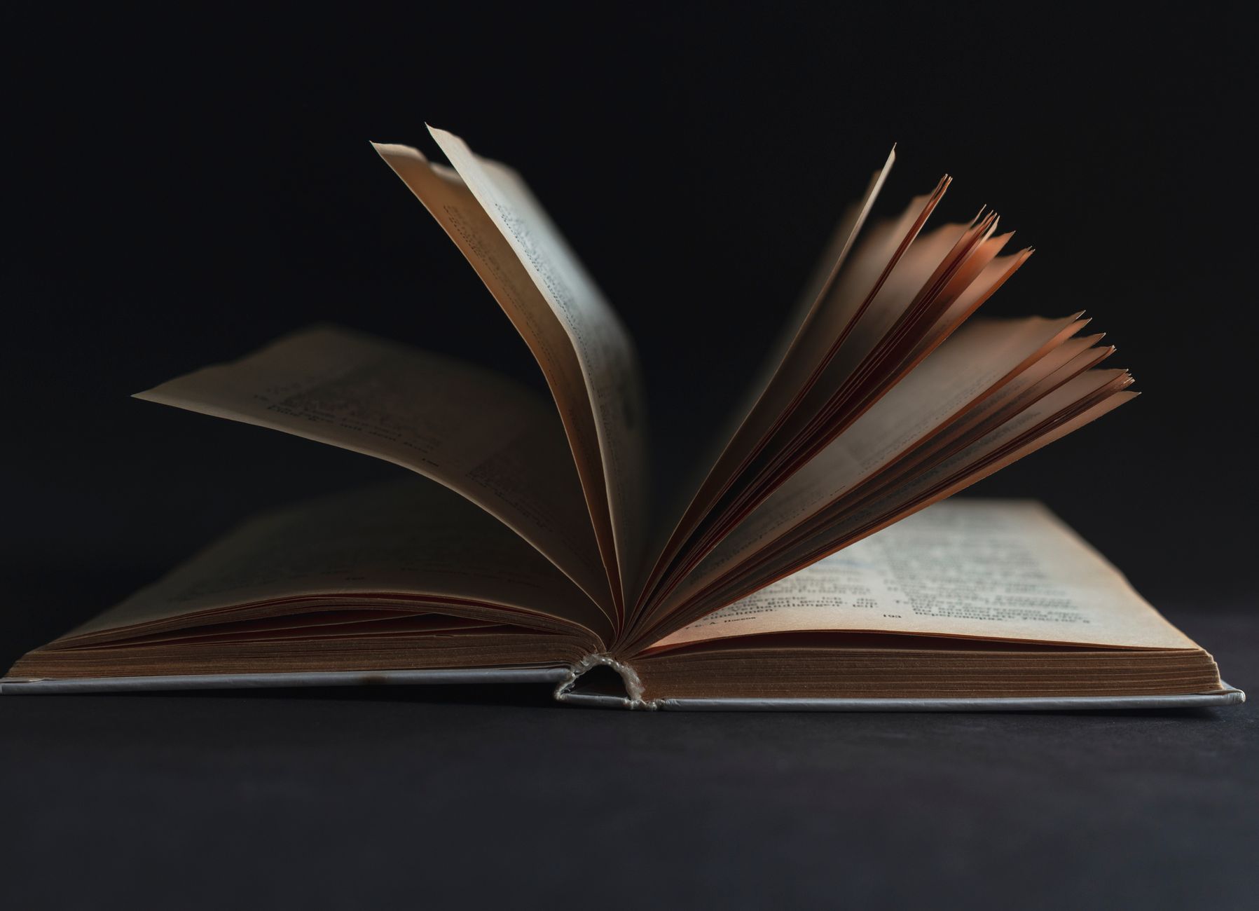 Worn copy of Shakespeare's collected works open on a wooden table
