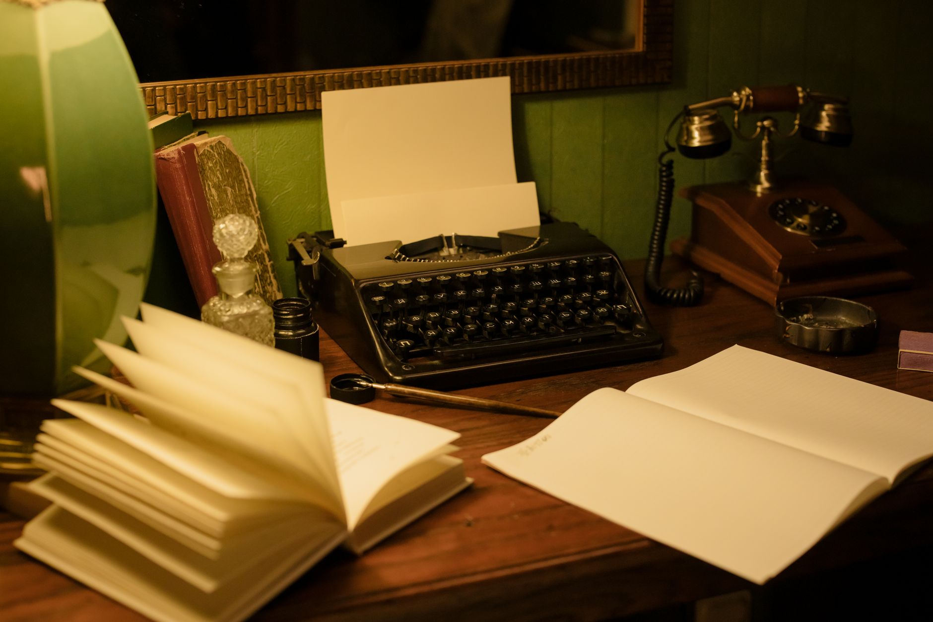 An old typewriter on a wooden desk with scattered handwritten notes