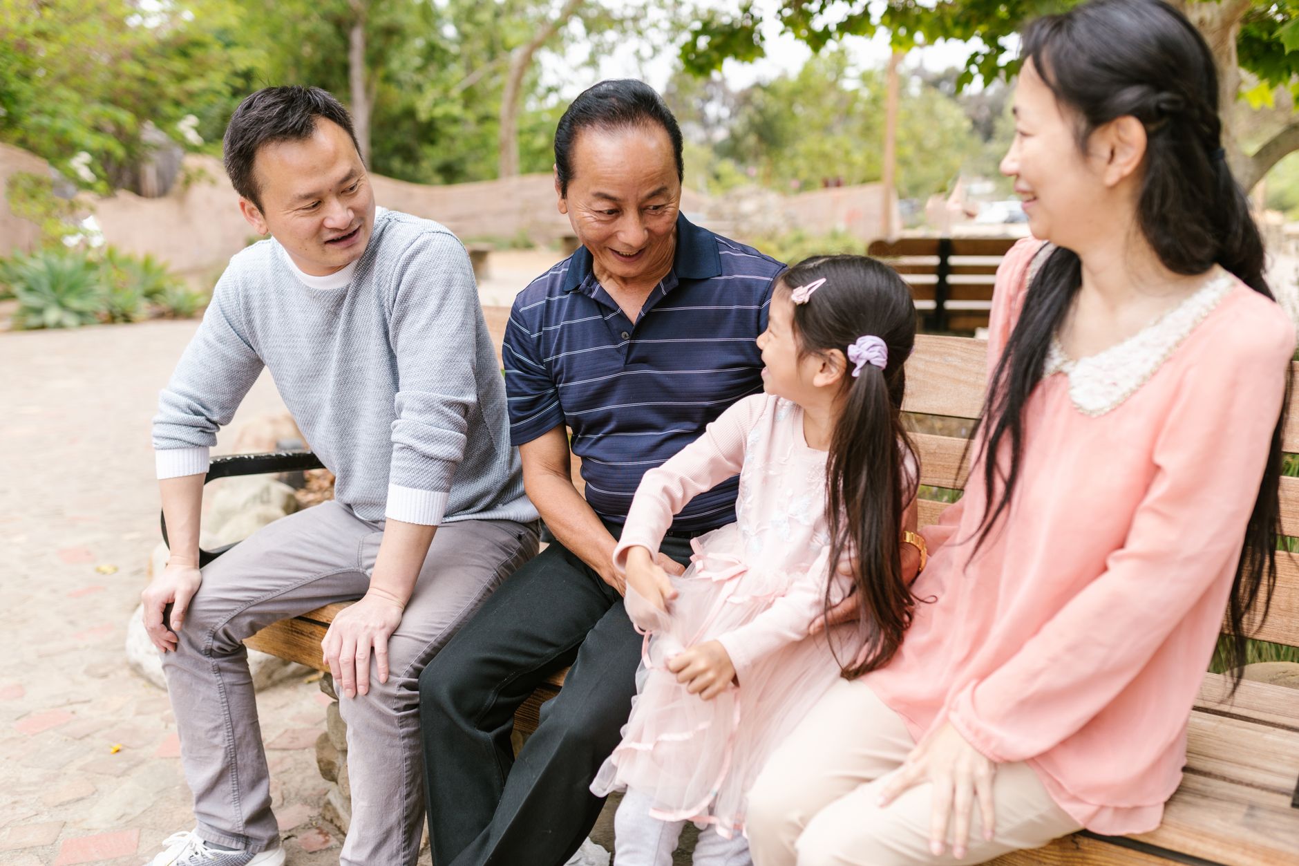 Elderly residents and children interacting outdoors in a community neighborhood setting