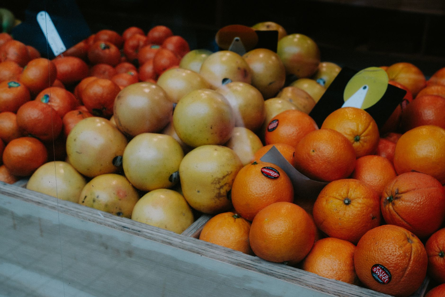 Colorful fresh fruit displayed at an outdoor farmers market stall