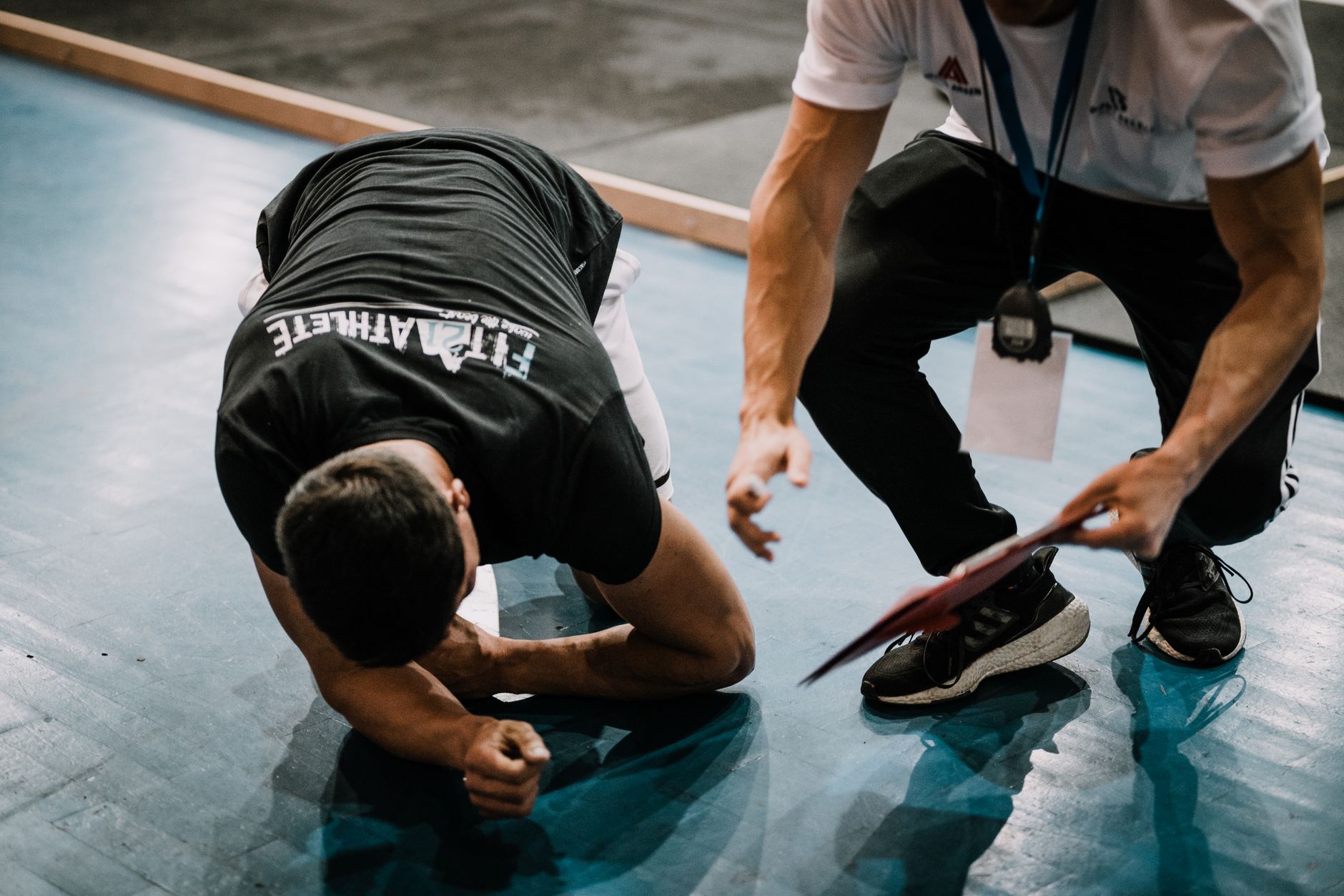 Personal trainer reviewing workout plan with a client in a gym setting