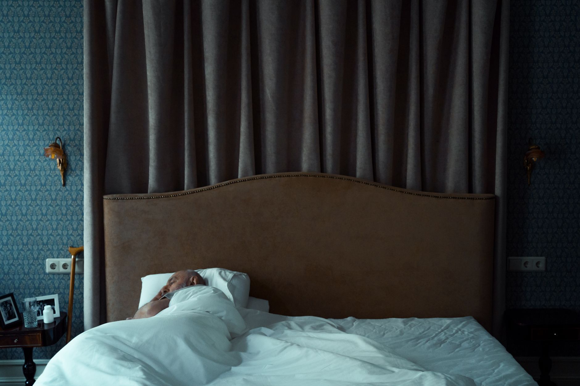 Person sleeping peacefully in a dark bedroom at night