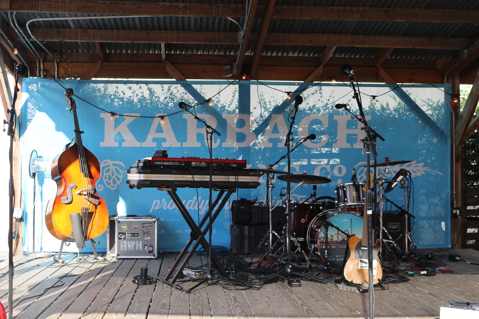 Live music performance on a stage with dramatic lighting and crowd silhouettes