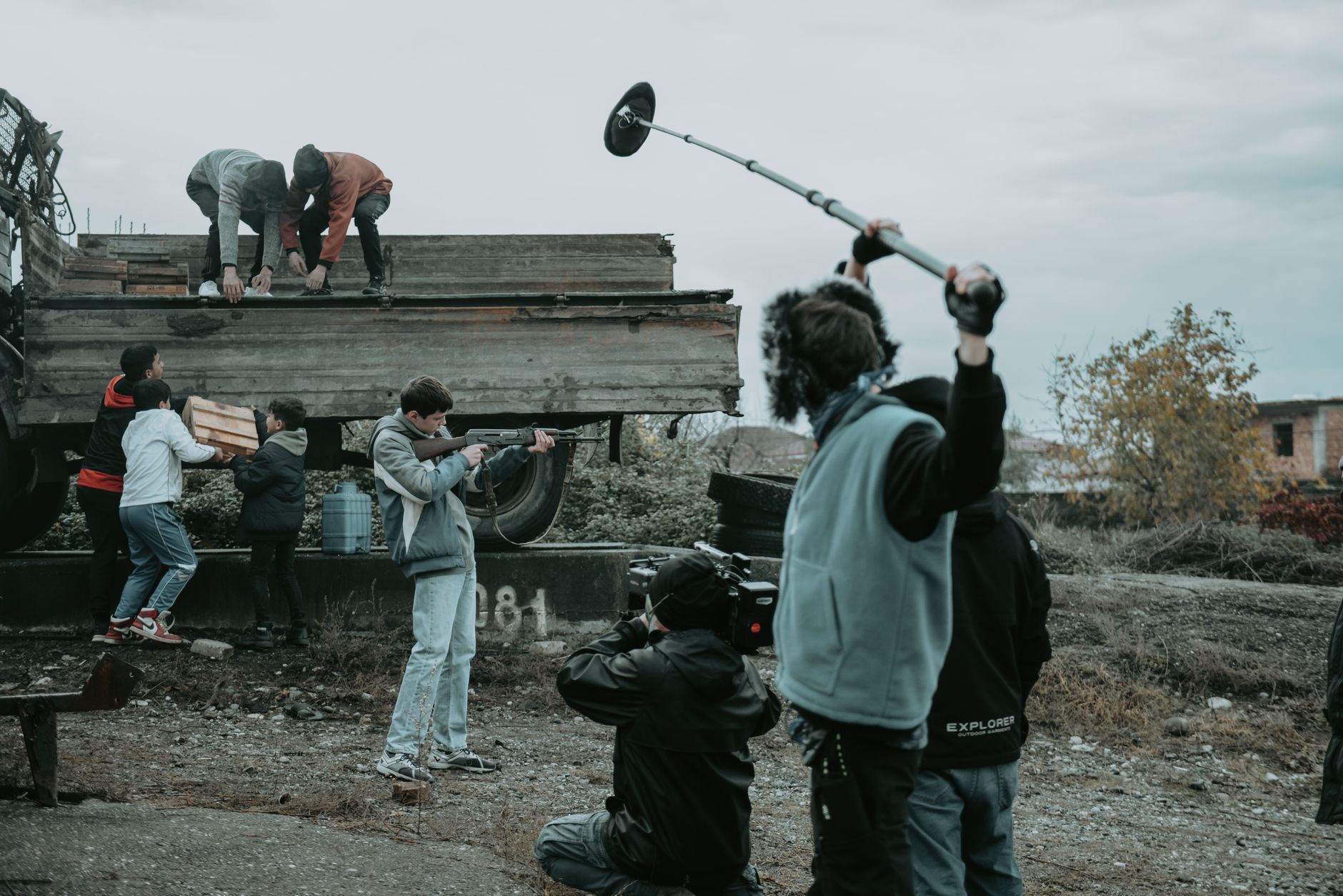 Film production set with dramatic lighting and camera equipment in the background