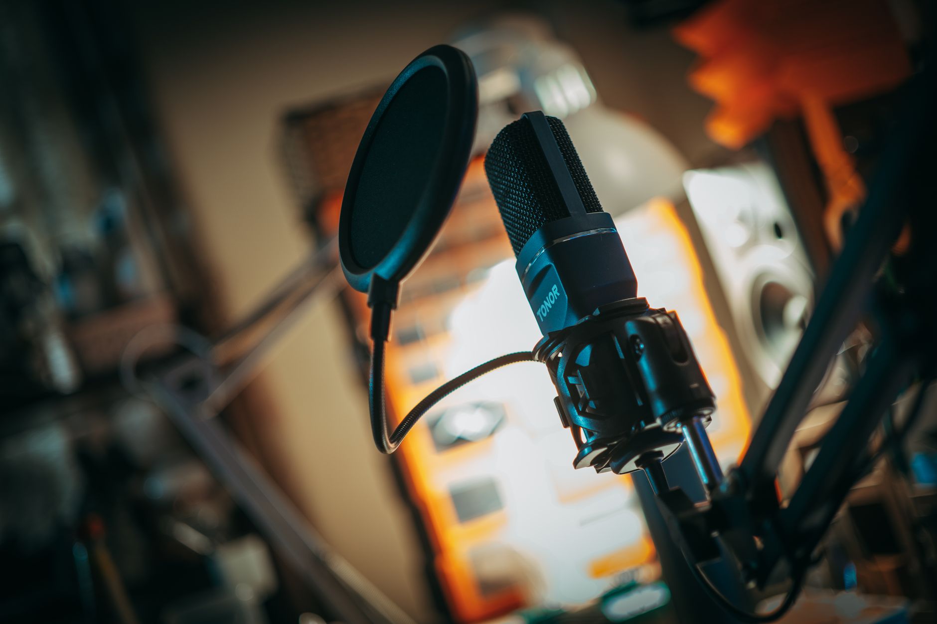 Microphone in a small recording studio with warm lighting
