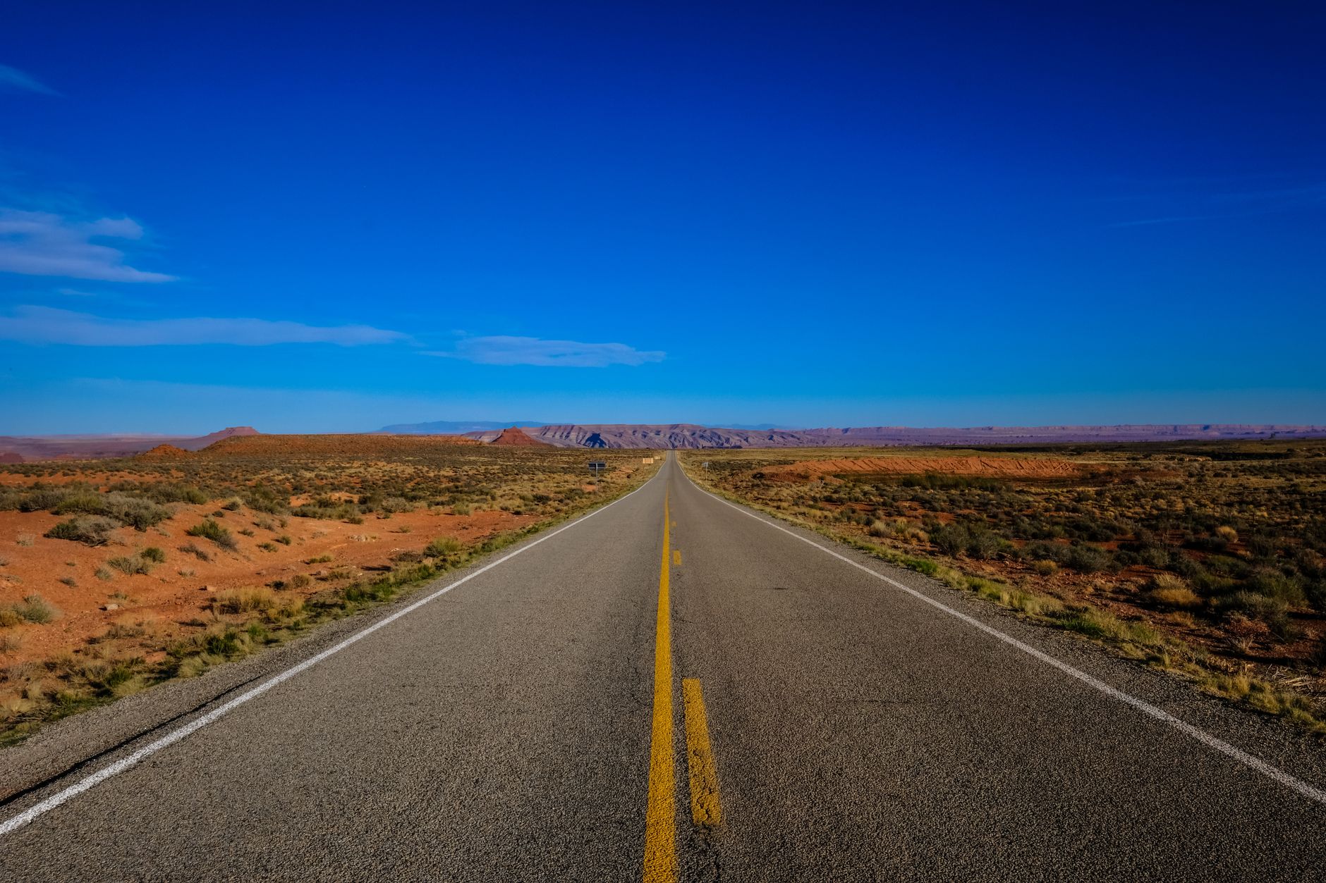 Open American highway stretching through a wide rural landscape