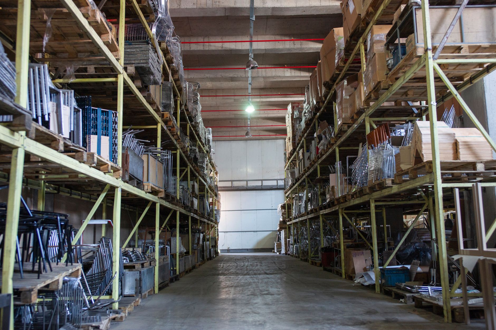 Long industrial shelving aisles inside a large warehouse facility