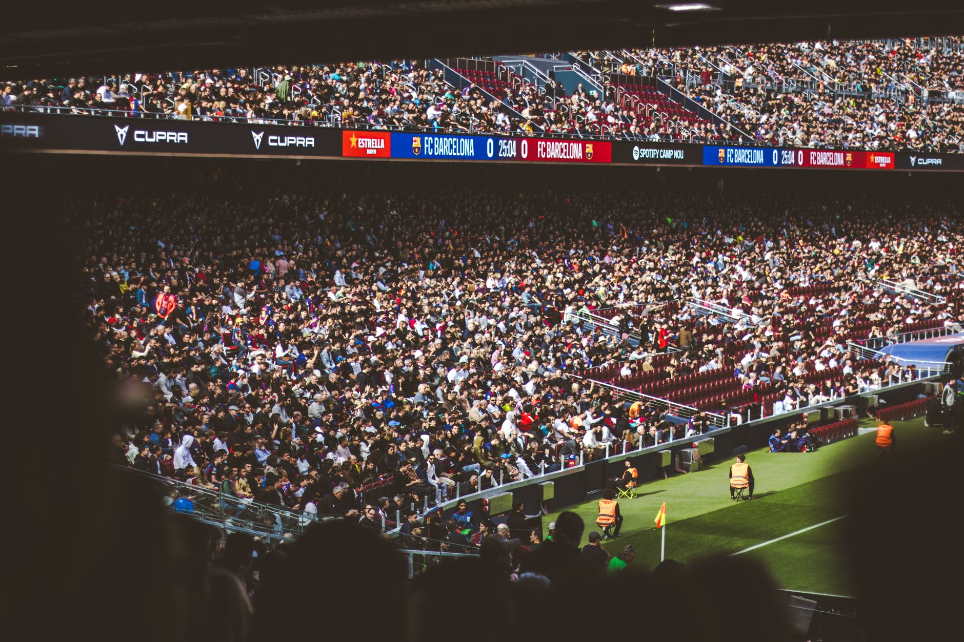 A packed stadium crowd watching a high-stakes professional tennis match