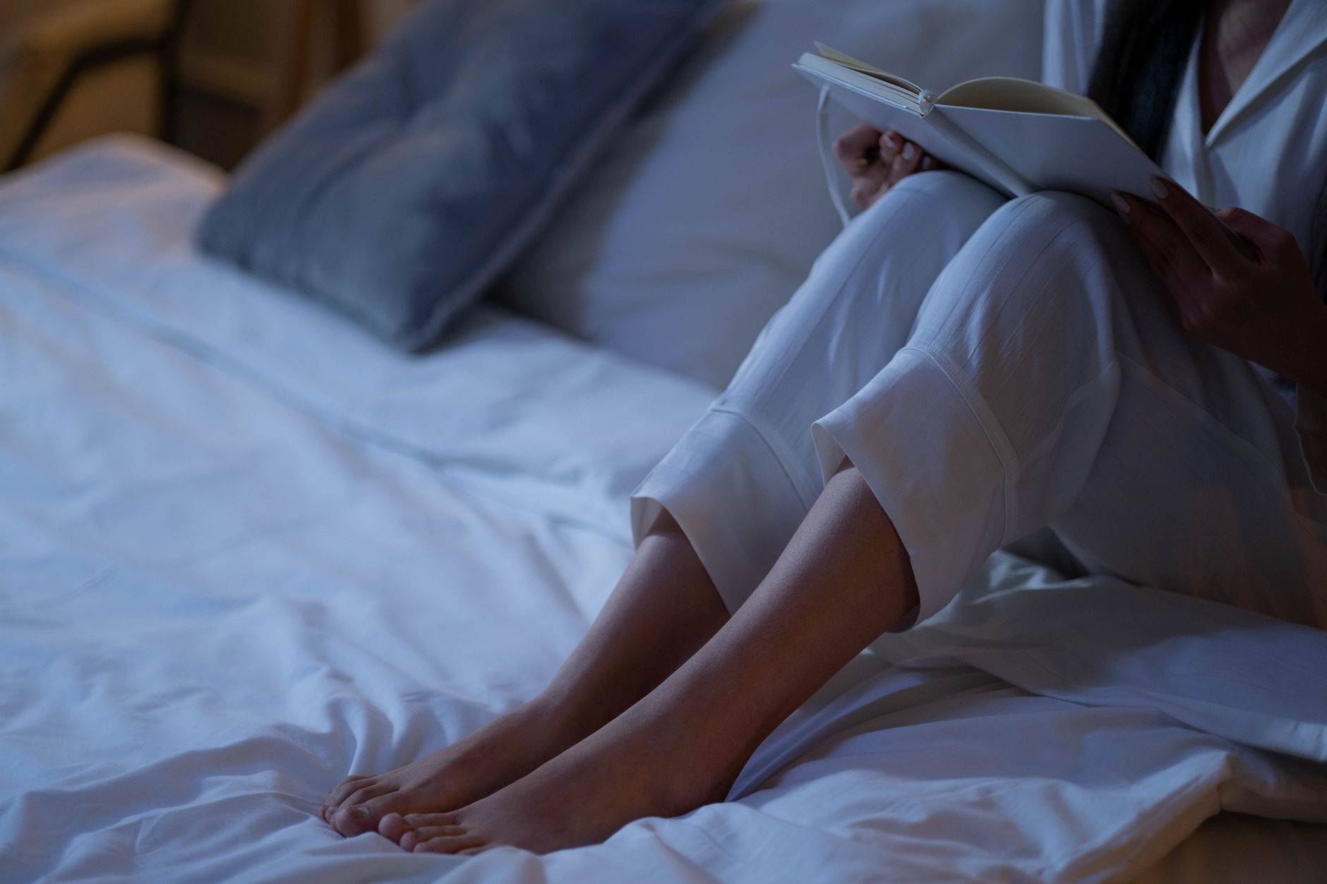 Dimly lit bedroom at night with lamp on nightstand