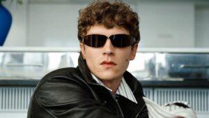 Male model with textured punk-inspired hairstyle in editorial fashion setting