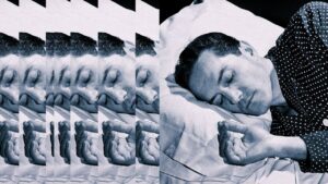 Sleep Debt Is Real, and Weekend Naps Person sleeping in a dark bedroom with white bedding