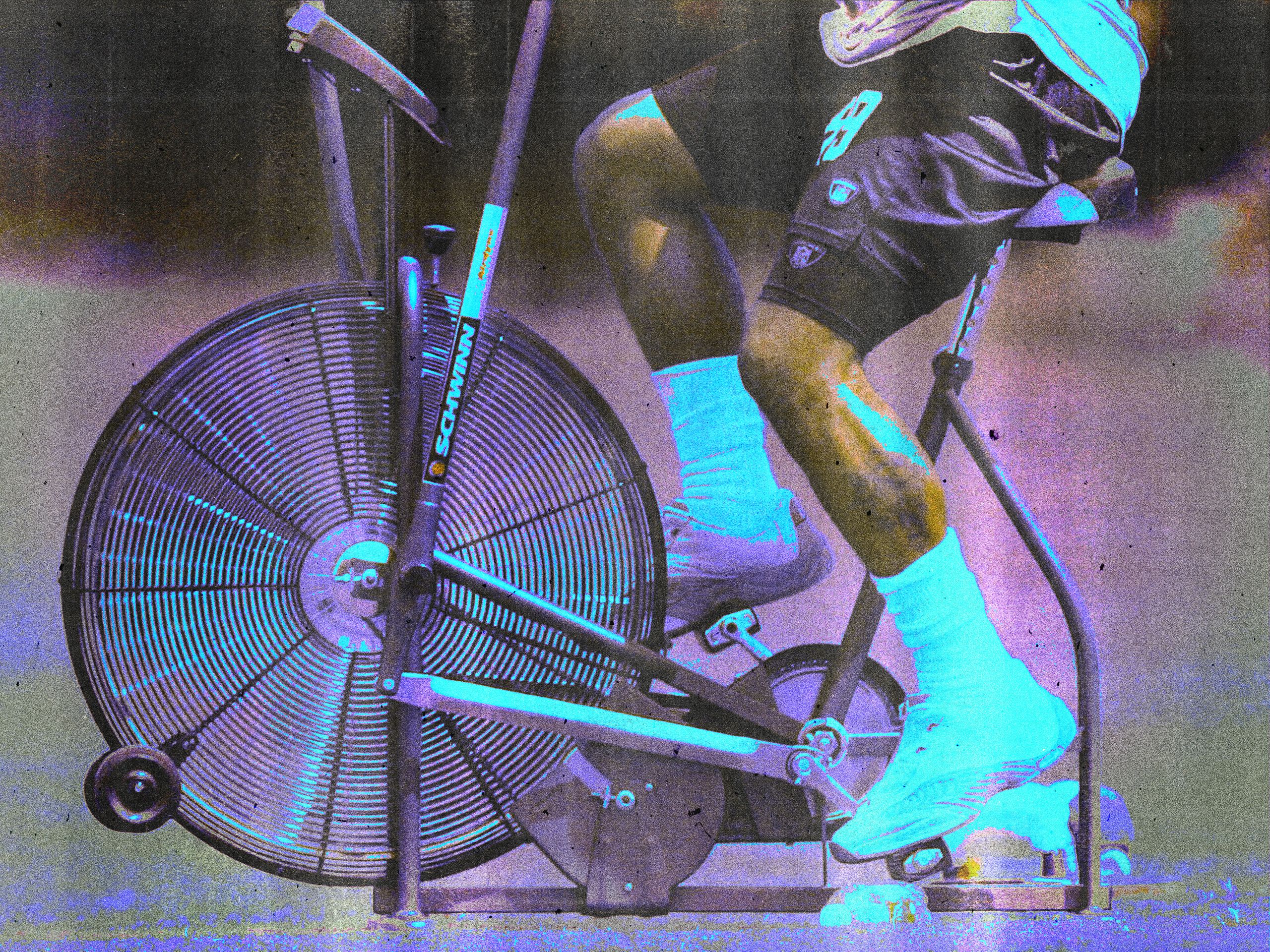 Woman on a stationary bike in a gym during a low-impact cycling workout