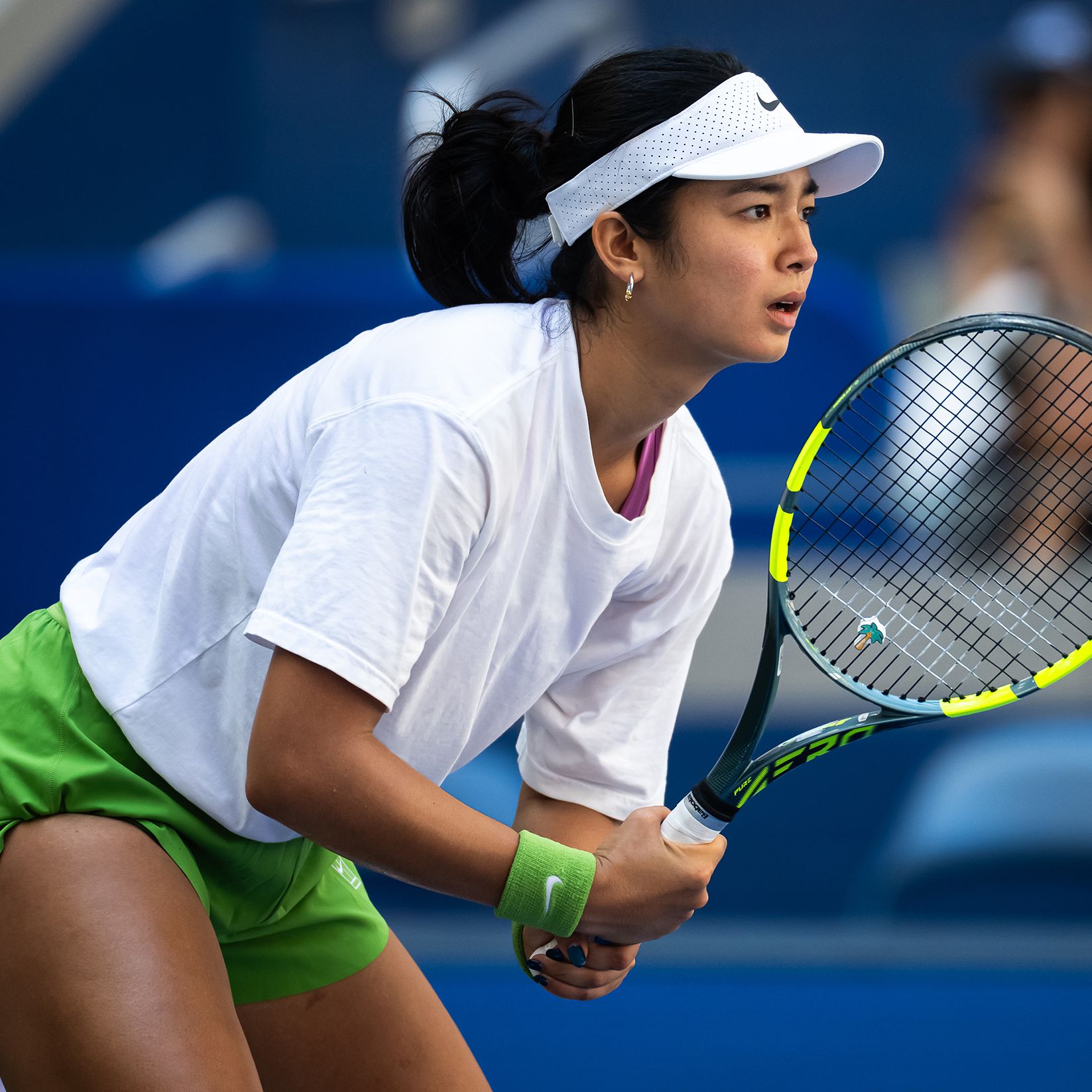 Close-up of a tennis racket and player mid-swing during an intense practice session