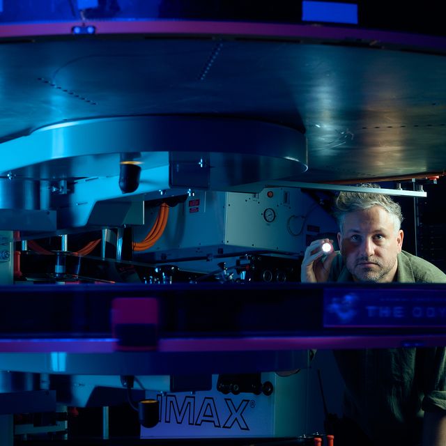 Interior of a large IMAX theater with oversized screen and empty seats