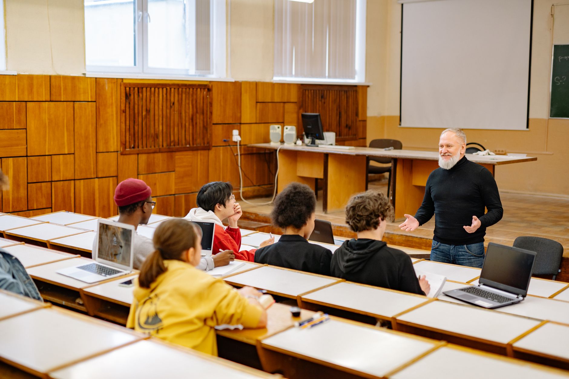 Students working on laptops in a modern public school classroom