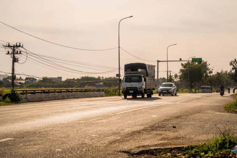 Electric semi truck driving on a highway at dusk