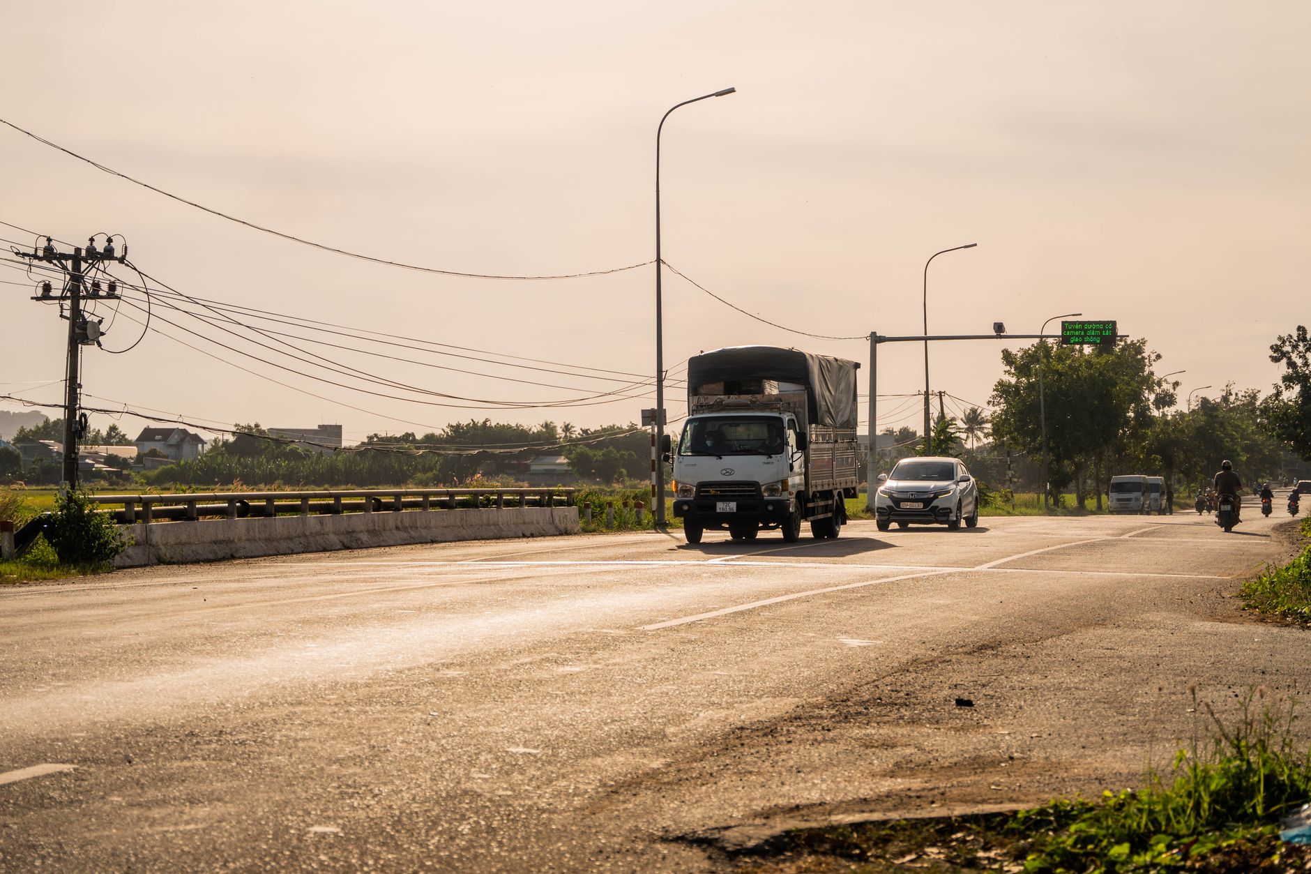 Electric semi truck driving on a highway at dusk