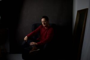 Dramatic moody portrait of a man in low light, evoking a cinematic atmosphere
