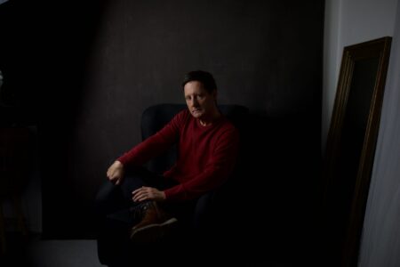 Dramatic moody portrait of a man in low light, evoking a cinematic atmosphere