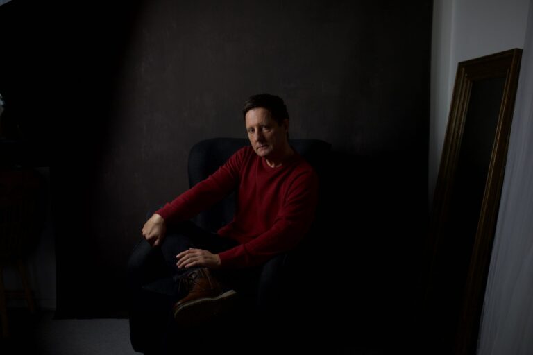 Dramatic moody portrait of a man in low light, evoking a cinematic atmosphere