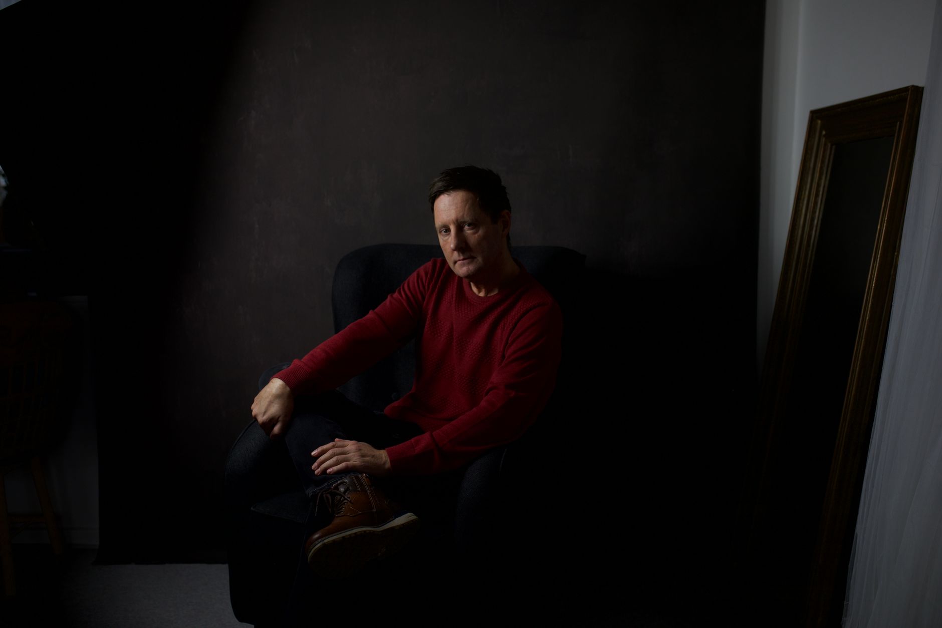 Dramatic moody portrait of a man in low light, evoking a cinematic atmosphere