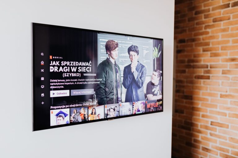 LG TV shown scanning LAN for third-party phones and other devices A large smart TV powered on in a dimly lit living room
