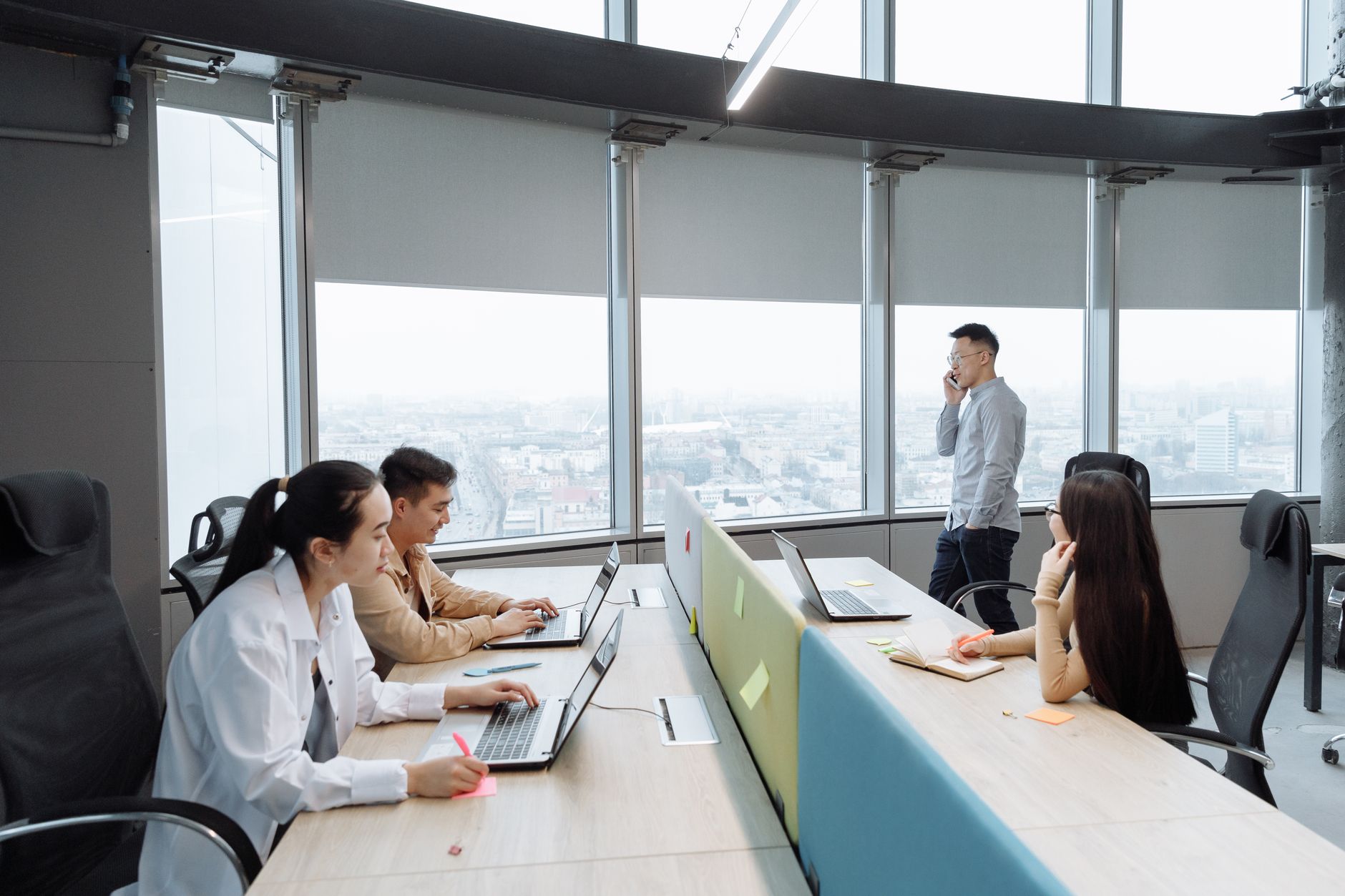 Office workers sitting at desks in a modern open-plan Manhattan office