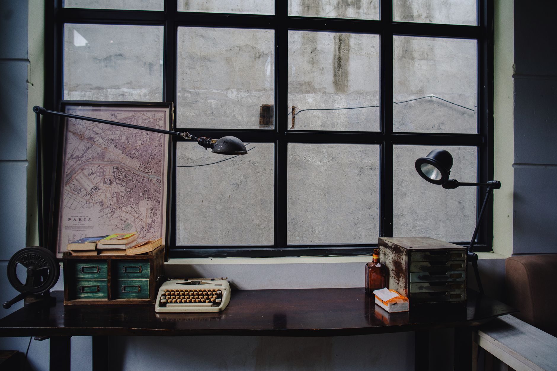 Aged wooden writing desk with paper, pen, and ink in natural light