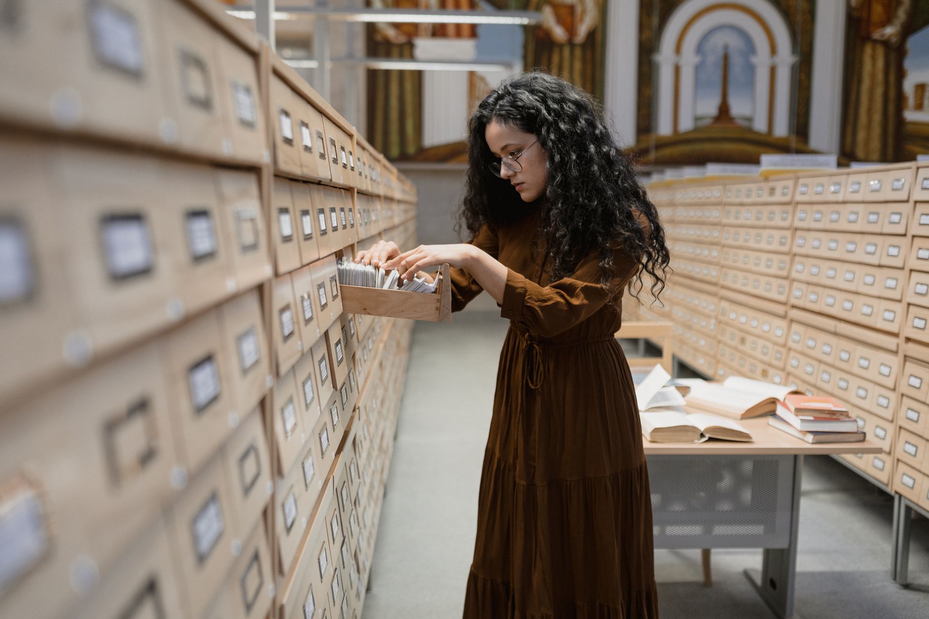 Rows of archived books and documents inside a dimly lit library