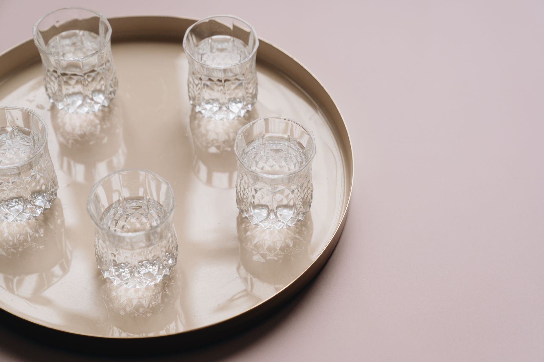A glass of water sitting untouched on a kitchen counter