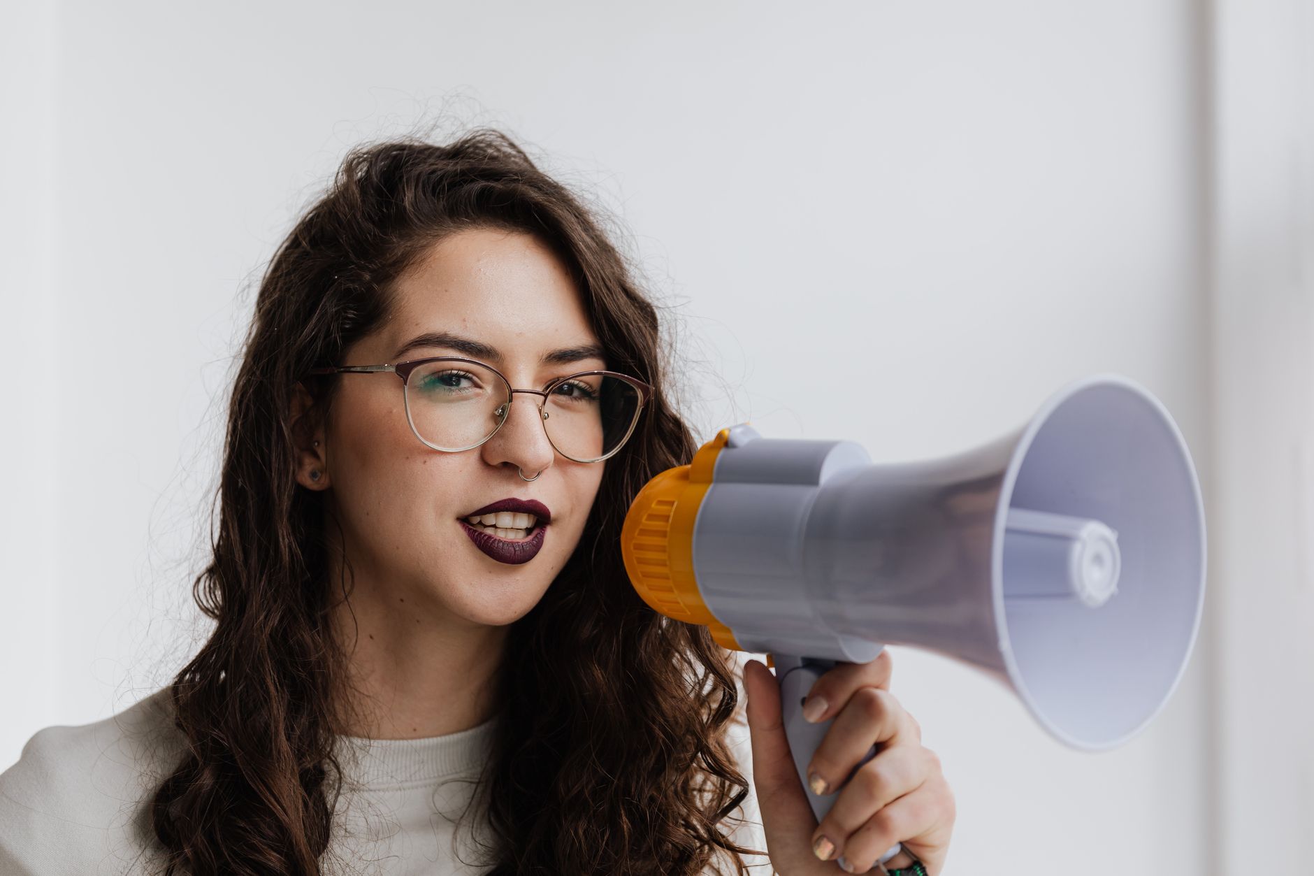 Woman speaking into a microphone at a formal public proceeding