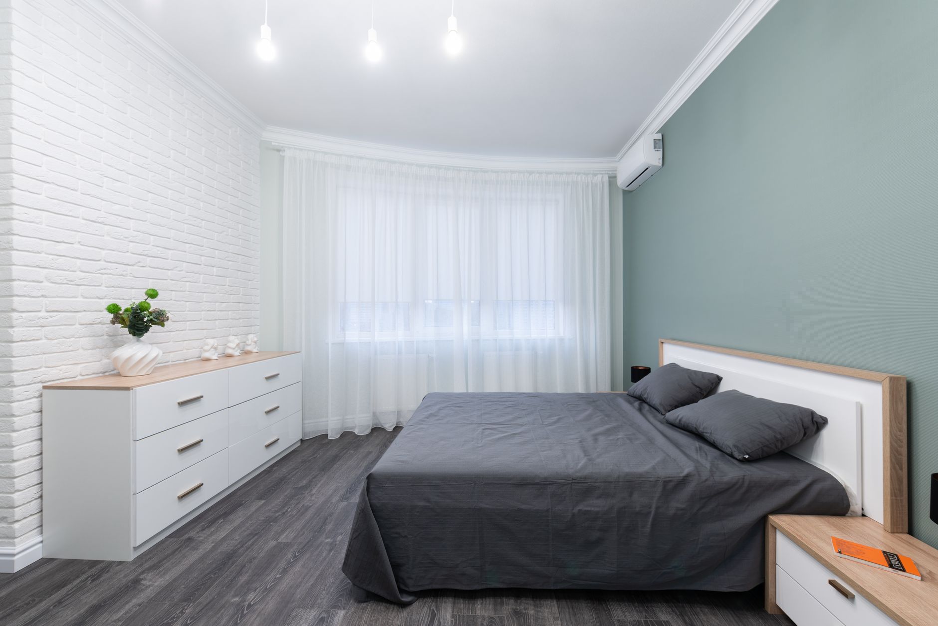 Minimal Parisian-style room with a single clothing rail and sparse decor
