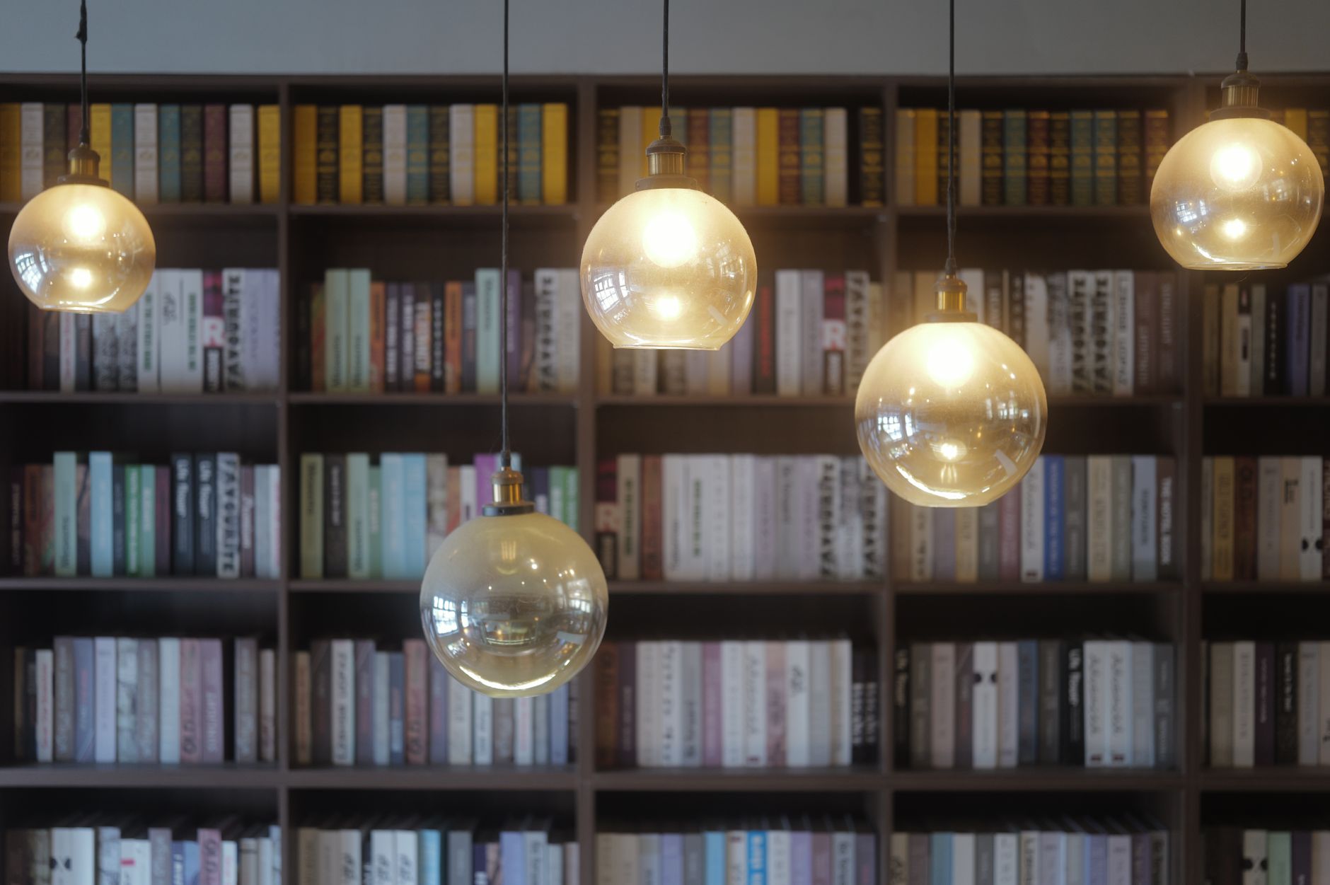 Rows of books on wooden library shelves