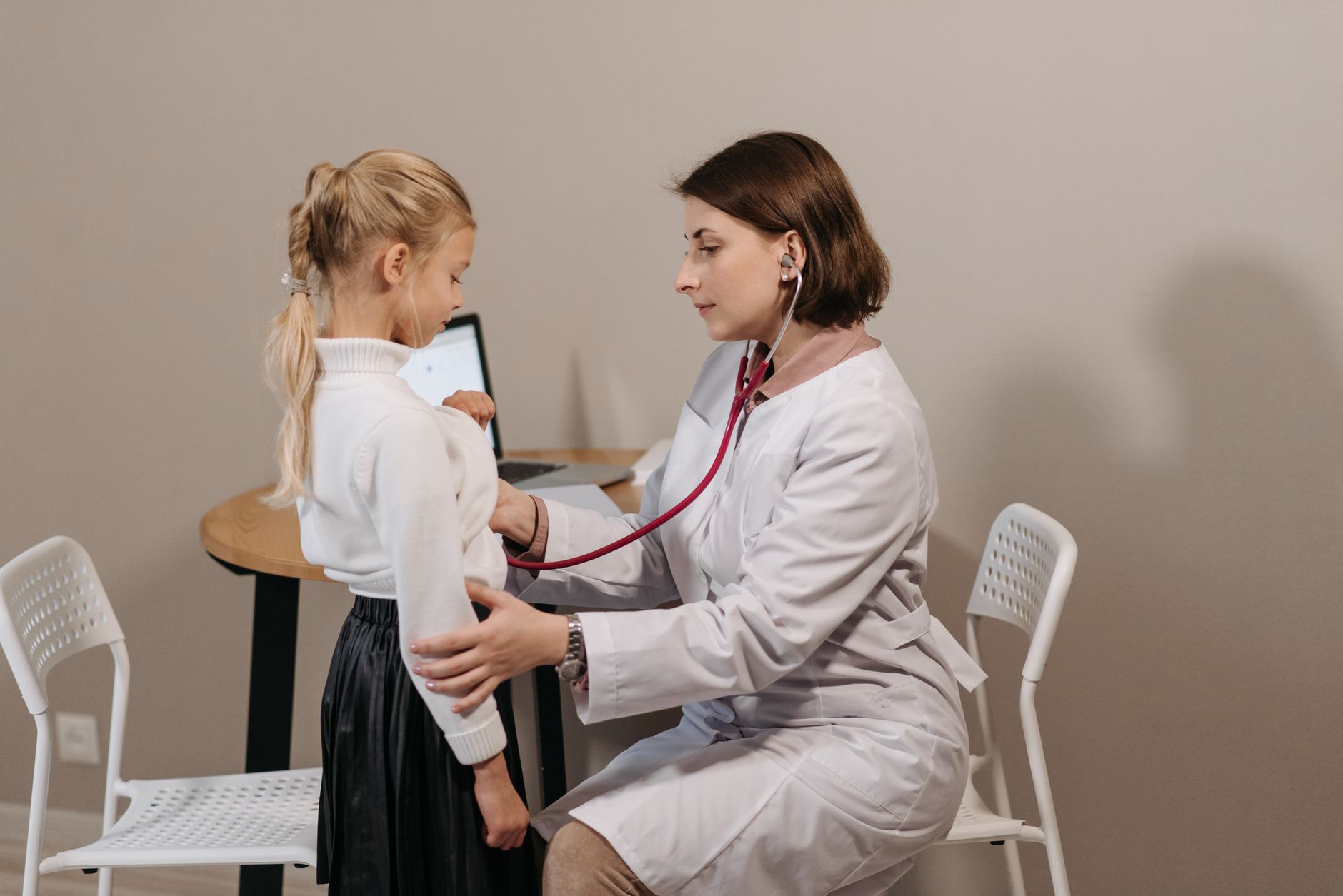 A child at a pediatric clinic visit representing vaccine access for low-income families