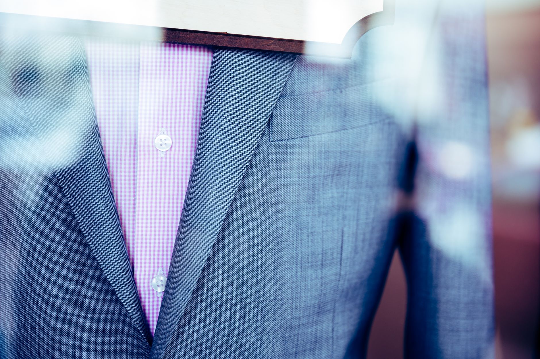 A close-up of a tailored suit jacket with textured fabric, suggesting the kind of considered dressing Bridges brings to major occasions