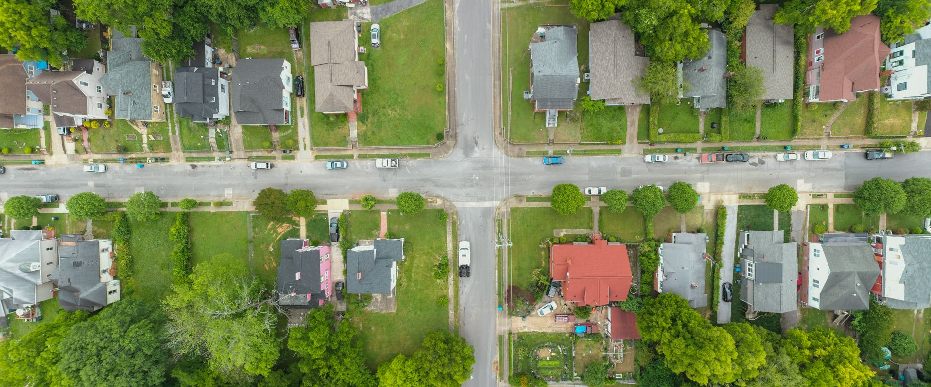 Row of suburban houses on a quiet residential street in soft afternoon light