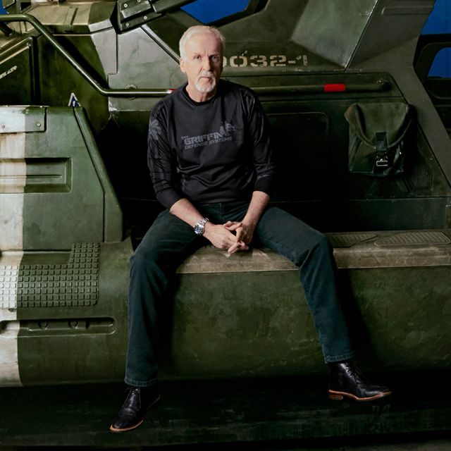 A film director standing on a large production set reviewing camera angles