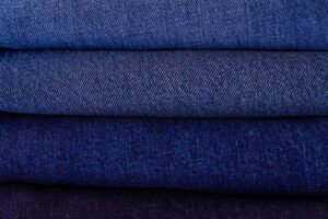 Close-up of tightly woven selvedge denim fabric showing the characteristic woven edge